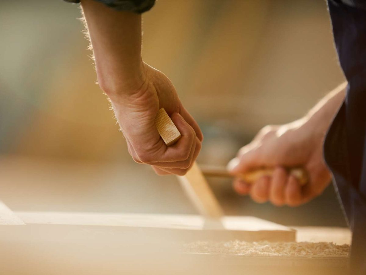 Close,Up,Of,Unrecognizable,Carpenter,Carving,Wood,While,Working,In