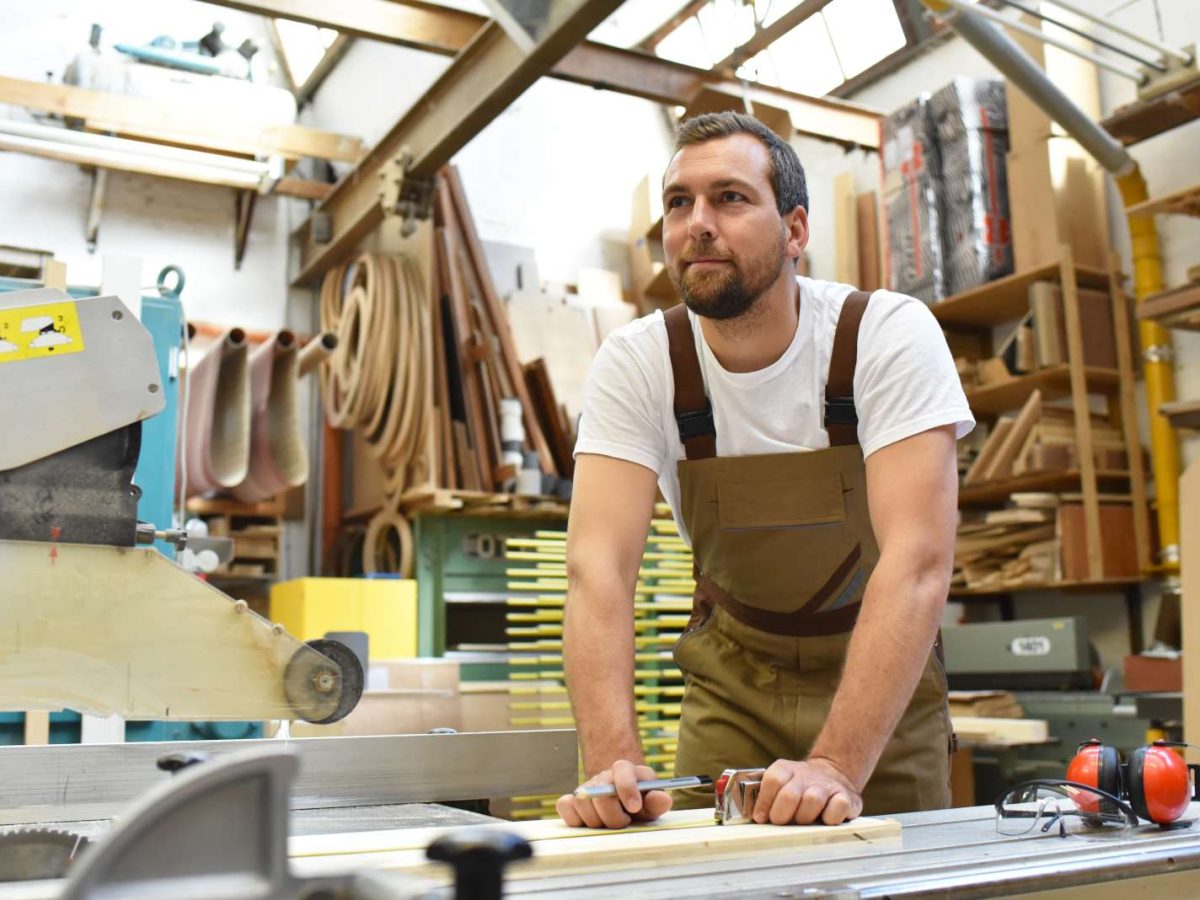 Friendly,Carpenter,With,Ear,Protectors,And,Working,Clothes,Working,On